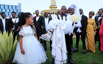 Habyarimana lifts his bride during a photo shoot on their wedding day. Courtesy