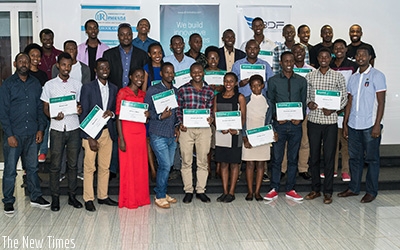 Students pose for a group photo with their certificates after graduation at the DMM.HeHe offices at Kigali Heights. Courtesy.