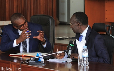 Chief Justice Sam Rugege (R) chats with Prosecutor General Jean Bosco Mutangana at the news conference. Sam Ngendahimana.