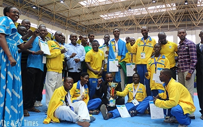 Rwandan players and staff pose for a group photo last year after clinching the best team of the tournament award and certificates. R. Bishumba