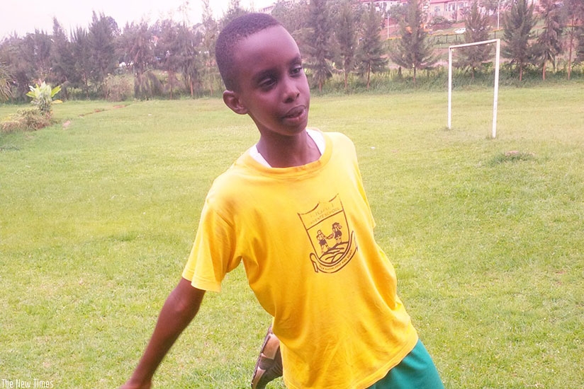 Lucky Gisa stretches after his soccer practice. / Joan Mbabazi.