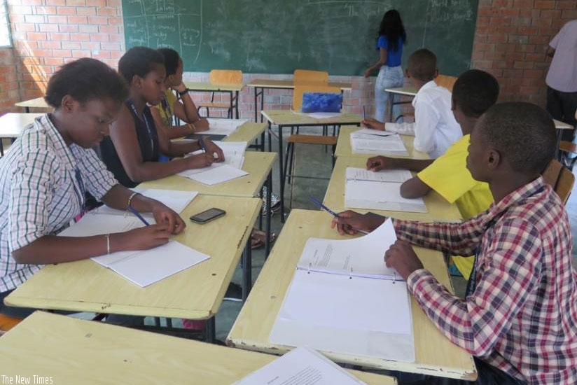 Students take notes during a lesson. Practising langauge skills such as writing, speaking and reading makes one better. / Lydia Atieno.