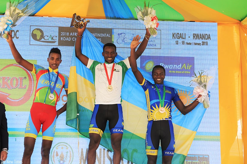 Joseph Areruya (C), Didier Munyaneza (R) and  Henock Mulueberhan display  their medals after winning during the African Road Race Championship in Kigali yesterday. Samuel Ngenadahimana.