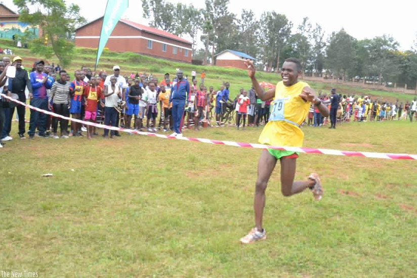 Thomas Dushimumukiza celebrates on crossing the finish line. Damas Sikubwabo. 