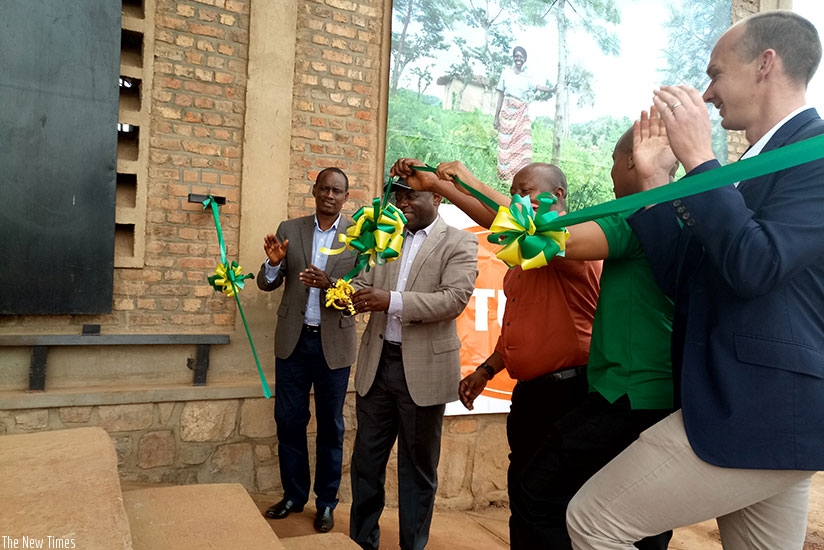 Nsengiyumva (in a black cap) cuts the ribbon to launch the fertiliser and seed wharehouse in Kayonza.  Emmanuel Ntirenganya.