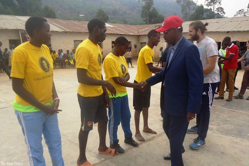 Deus Sangwa Board Chair greets some of the athletes. File
