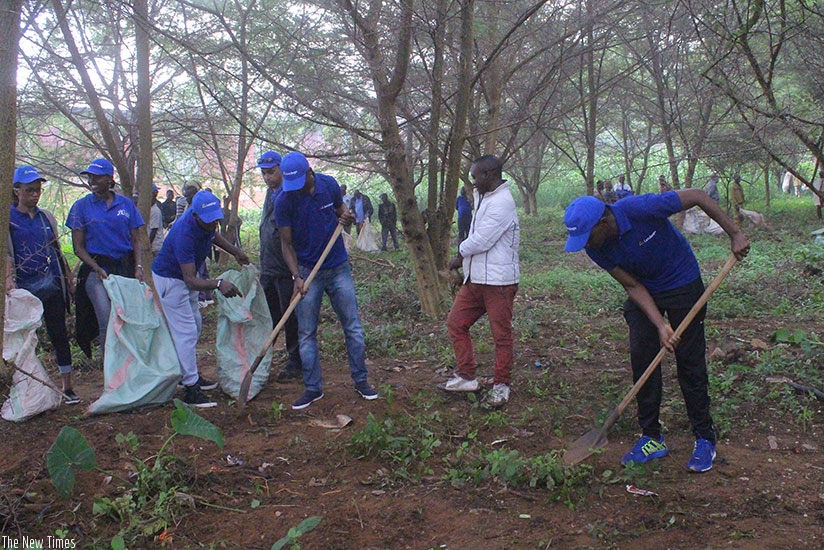 Muhima residents  with Letshego Rwanda staff clearing Nyabugogo marshland during Umuganda community service. Frederic Byumvuhore