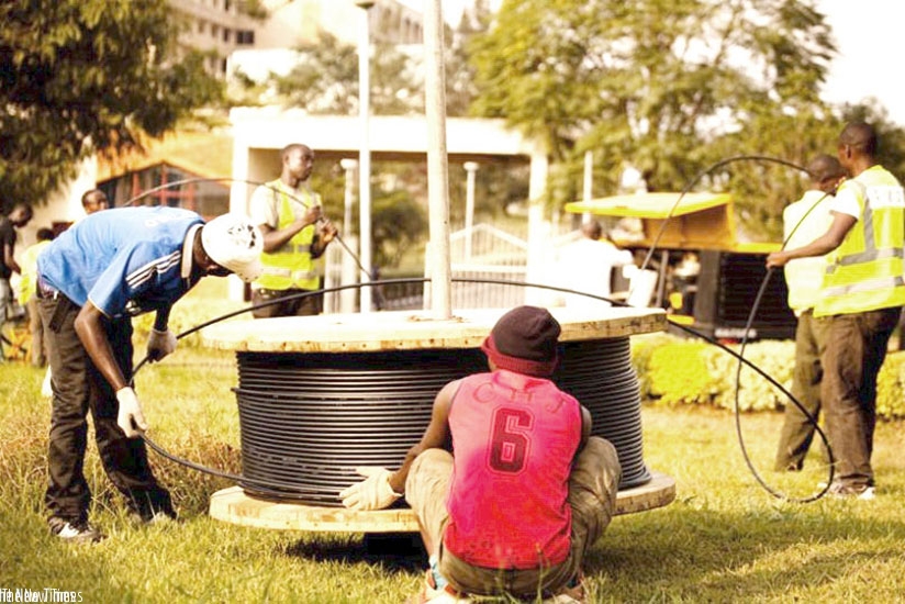 Telecom workers install fibre optic cables in Kigali. File.