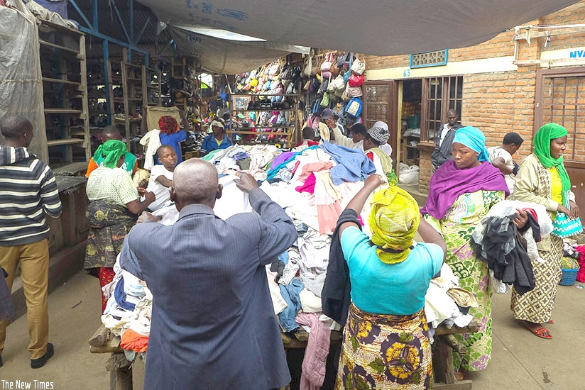 Vendors and prospective buyers sort used clothes in Rubavuu2019s Mahoko market. File