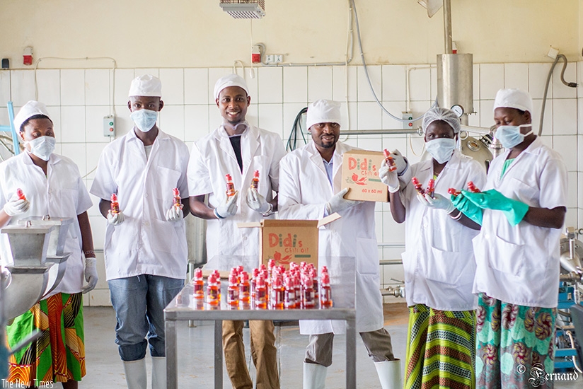 Twahirwa (2nd right) with his employees at the factory. (Courtesy)