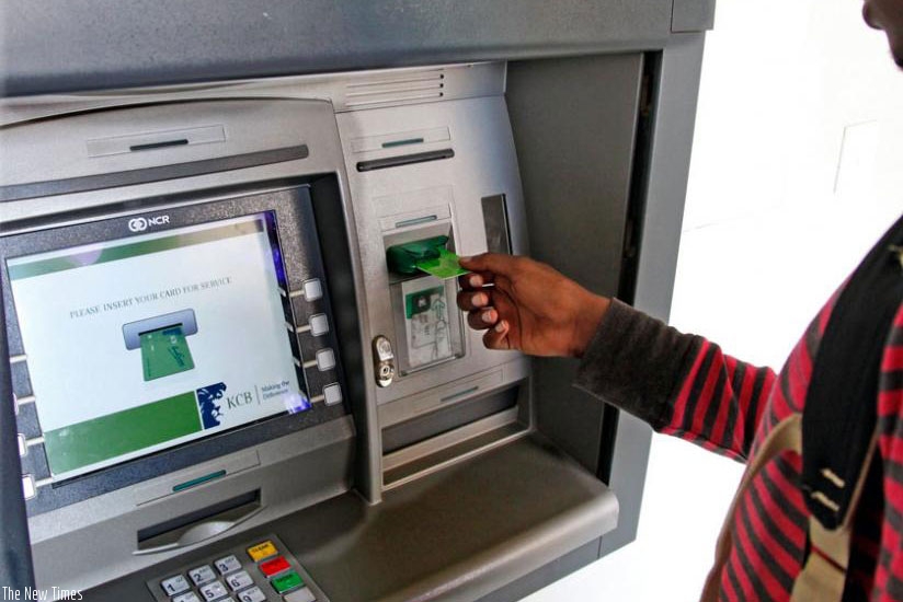 An ATM user in Kigali. File.