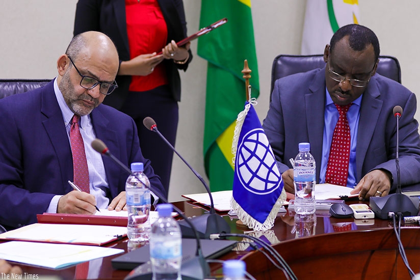 Yasser El-Gammal, the World Bank Country Manager (L), signs documents with Claver Gatete, the Minister for Finance and Economics (All photos by Timothy Kisambira)