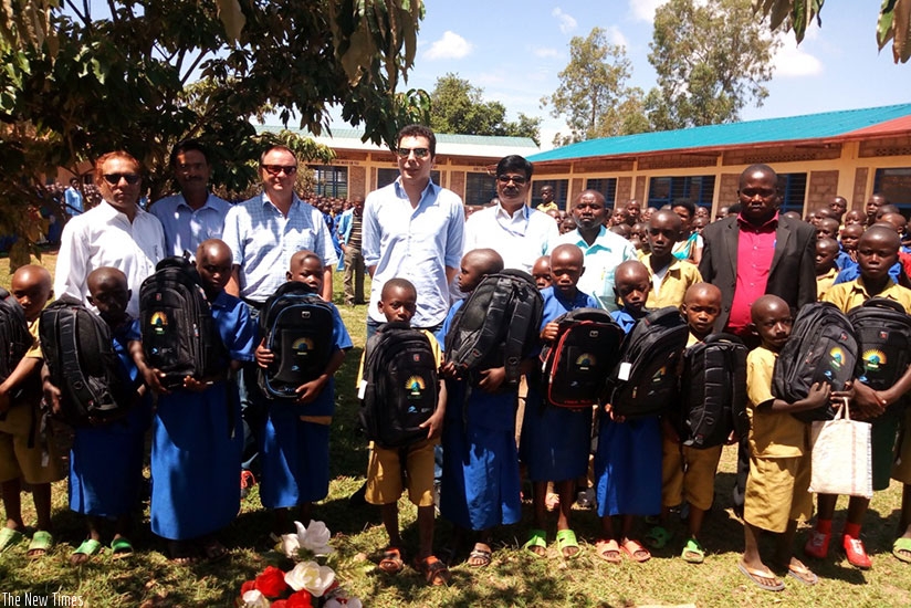 The HQ Power team with some of the 498 pupils who received the scholastic materials. (Kelly Rwamapera)