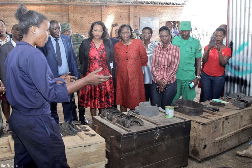 Umuhire explains to senior government officials how her brake bands work. rn(Regis Umurengezi)