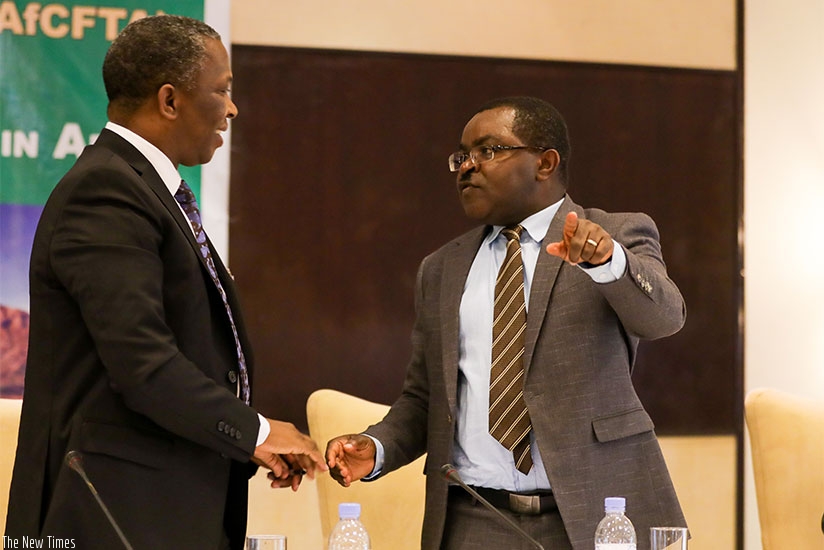 The Swazi Minister for Commerce, Industry and Trade Jabulani C. Mabuza (L) chats with Rwandan Minister for Trade and Industry, Vincent Munyeshyaka, at the meeting in Kigali yesterd....