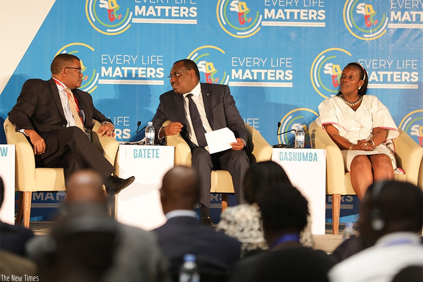 Dr Belay Begashaw, the Director-General of SDGCA (L), chats with Minister Gatete as Minister Gashumba (R), looks on in Kigali yesterday. Timothy Kisambira.
