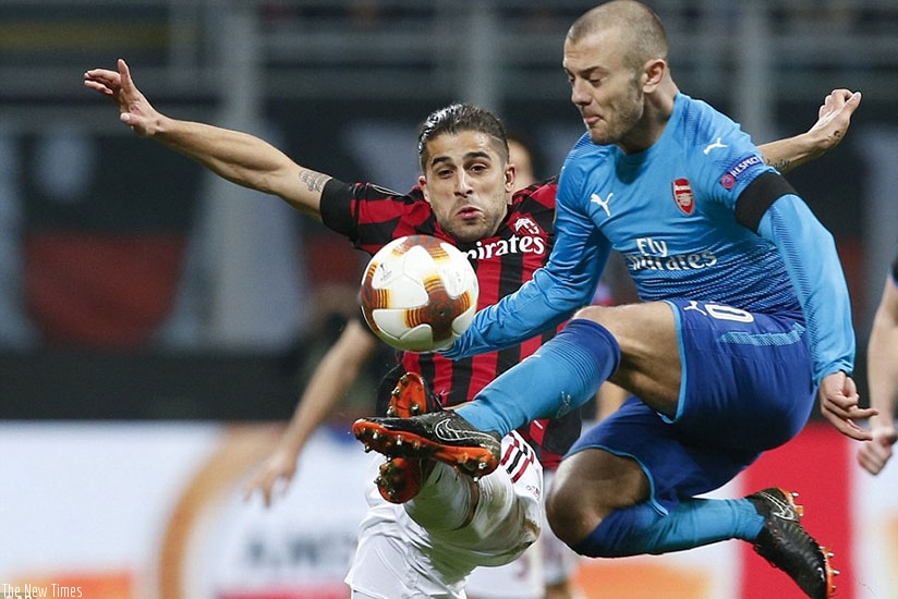 Jack Wilshere competes for the ball against Ricardo Rodriguez as Arsenal were largely comfortable against a poor Milan side. Net photo