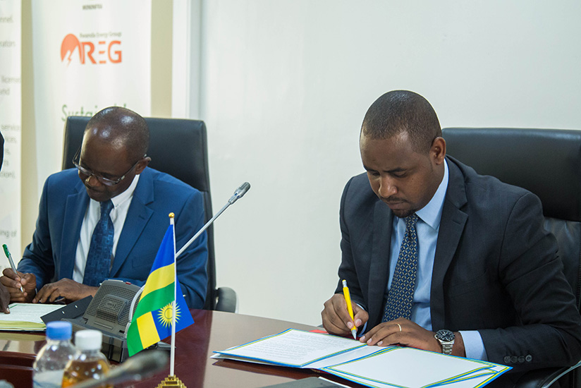 Prof. Makame Mbarawa, the Minister for Transport of Tanzania (left), and Rwanda's Minister of State in charge of Transport Jean de Dieu Uwihanganye sign the railway construction ag....