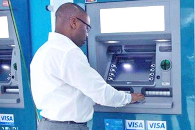 An ATM user in Kigali. File.