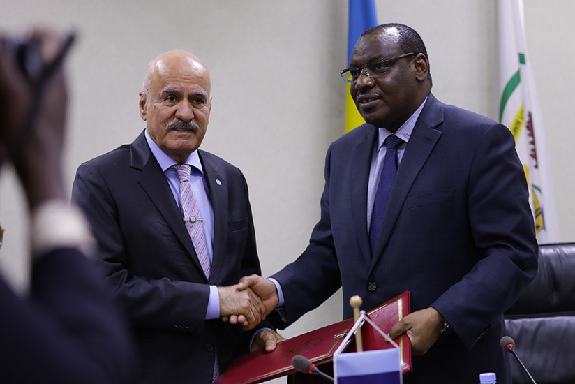 OFID Director-General Suleiman J Al- Herbish (L) exchanges documents with Claver Gatete, the Minister for Finance and Economic Planning, yesterday. Timothy Kisambira. 