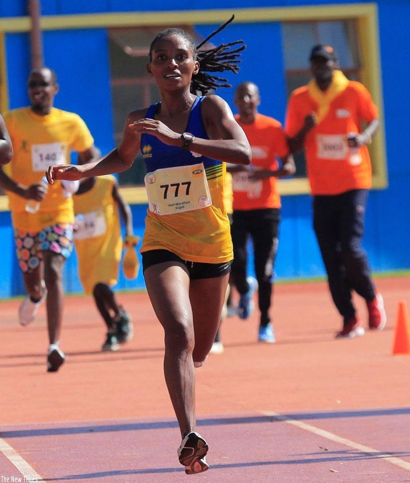 Nyirarukundo crosses the finish line to win last yearu2019s Kigali International Peace Half Marathon. (File)