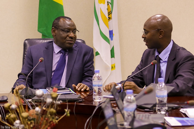 The Minister for Finance and Economic Planning, Amb. Claver Gatete (L), chats with Yusuf Murangwa, Director-General, National Institute of Statistics of Rwanda in Kigali yesterday ....