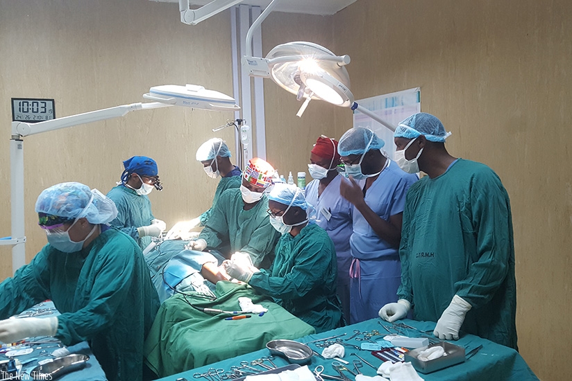 A team of visiting facial plastic surgeons and local surgeons attend to patients with such facial and oral cleft defects at Rwanda Military Hospital last week. / Courtsey photos.