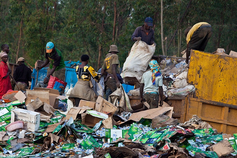 Workers at Nduba dump site in Gasabo District sort out gabbage. (Timothy Kisambira)