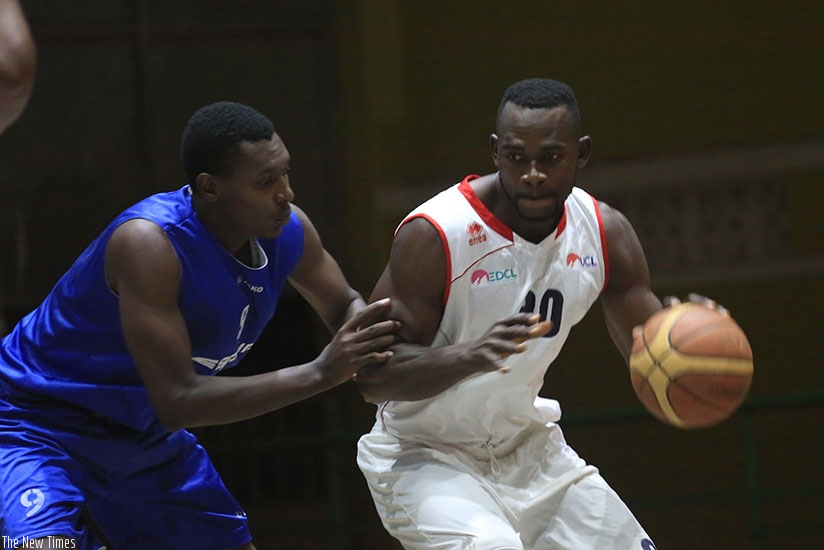 Bienvenue Ngandu (with ball) of REG fends off Regis Gatoto of Espoir during a past league game. Sam Ngendahimana.