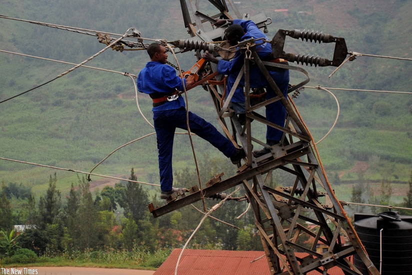 Rwanda Energy Group workers fix electric cables. File. 