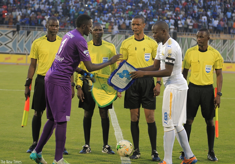 Skippers Eric Ndayishimiye of Rayon Sports and his Sundowns counterpart, Kekana Hlompho exchange their teamsu2019 flag before the first leg match. S. Ngendahimana