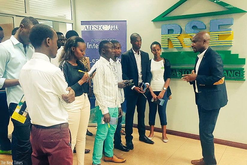 RSE chief executive Pierre-Celestin Rwabukumba (right) explains to students how the bourse operates. / Marie Anne Dushimimana.