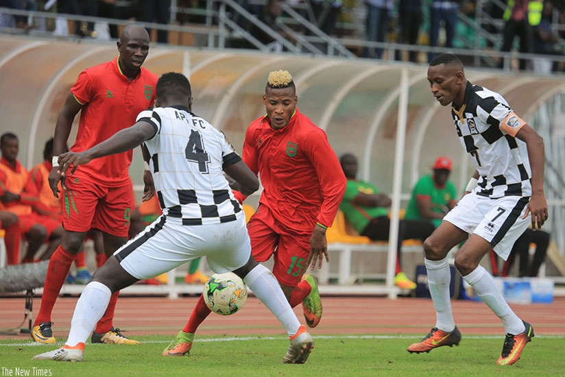 Djoliba forward Naby Soumah tries to dribble past APR defender Herve Rugwiro (#4) and midfielder JB Mugiraneza during the second leg match at Amahoro Stadium. Sam Ngendahimana.