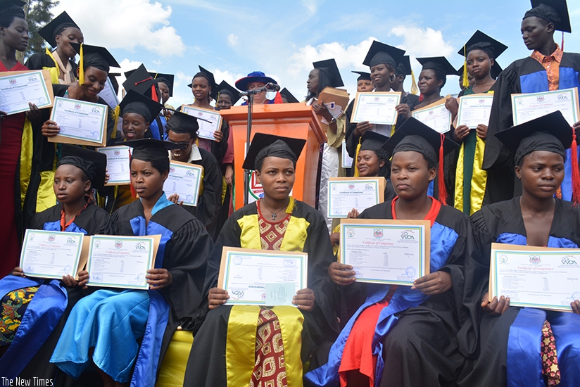 The graduates display their certificates at the ceremony. (Frederic Byumvuhore)