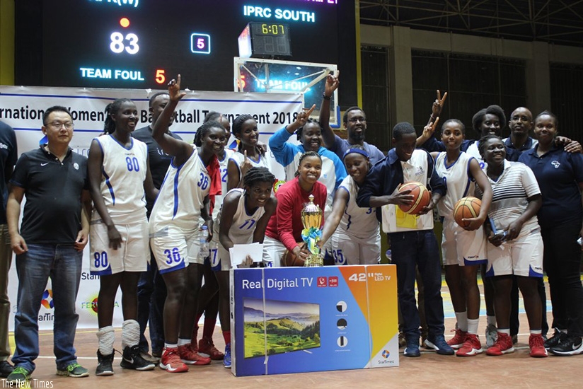 IPRC-South celebrate with the trophy after overcoming APR in the final at Amahoro Indoor Stadium. (R. Bishumba)