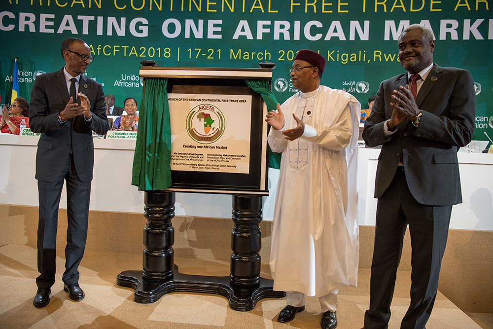The Chairperson of the African Union, President Paul Kagame; the Champion of the African Continental Free Trade Area, President Mahamadou Issoufou of Niger; and the Chairperson of the African Union Commission, Moussa Faki Mahamat (right), applaud after unveiling a plaque marking the official launch of CFTA at Kigali Convention Centre on Wednesday.  The signing of the instrument by 44 countries paves the way for yet another critical stage geared at bringing CFTA into force. / Village Urugwiro.