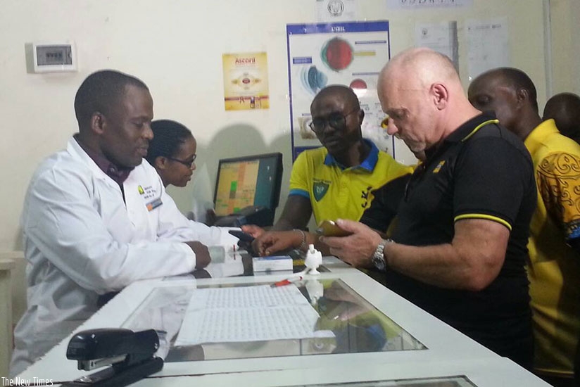 MTN CEO Bart Hofker uses the MoMo Pay platform at a registered pharmacy. ? M. Dushimimana