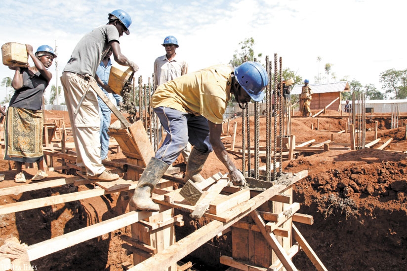 Builders at a construction site in Kigali last year. File. 