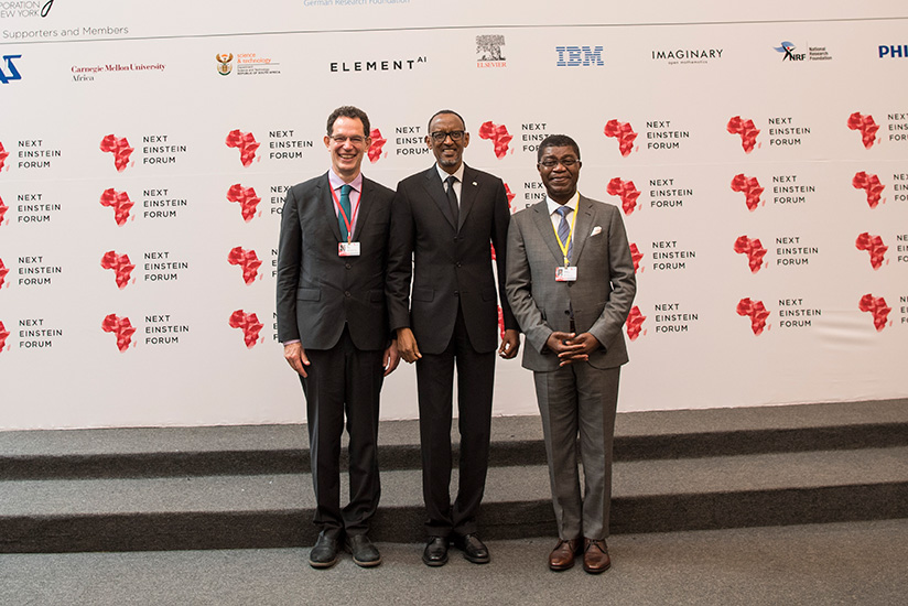 President Paul Kagame with Prof. Neil Turok, the founder of The African Institute for Mathematical Sciences (AIMS) (left) and Thierry Zomahoun, AIMS President and CEO & Next Einstein Forum founder (right), during the  official opening of the ongoing forum yesterday. / Village Urugwiro