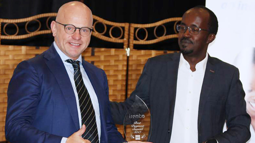 Hofker receives a gift from Uwajeneza after the launch. (Peterson Tumwebaze)