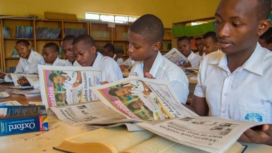 Students reading copies of The New Times (File)