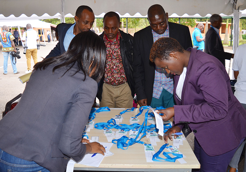 Government officials get identification numbers and luggage tags before heading for a retreat. 