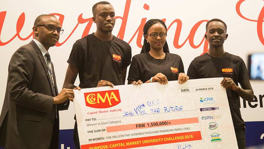 Vision Quest team members receive a dummy cheque for prize cash from Rwigamba. The official urged them to encourage other youths to save. (Courtesy)