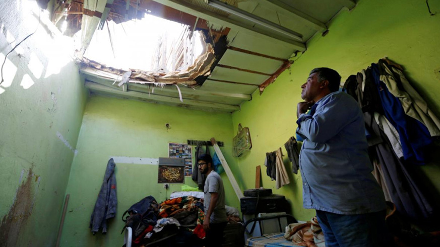 People check the damage after debris from ballistic missiles fired by Yemen's Houthi militia fell onto a house in Riyadh, Saudi Arabia March 26, 2018. / Courtesy