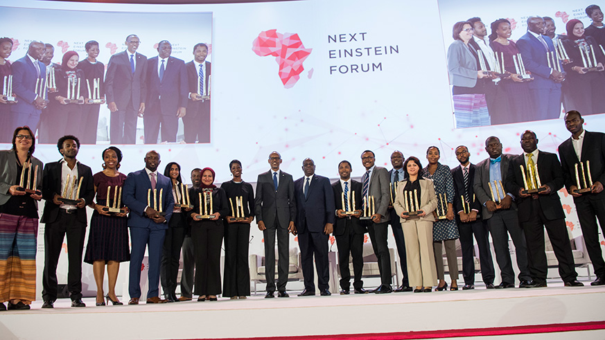 Presidents Paul Kagame of Rwanda and Macky Sall of Senegal (centre) pose for a group photo with 17 African scientists who were recognised for their outstanding contribution towards advancing science on the continent, yesterday. The awardees were recognised on Day II of the ongoing Next Einstein Forum meeting in Kigali, the second edition of the biennial science gathering. Kagame, the current African Union Chairperson, pledged AUu2019s support towards promotion of science and innovation on the continent.  (Photos by Village Urugwiro)