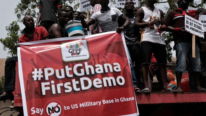 Demonstrators carry banners during a protest in Ghana's capital Accra against the expansion of its defence cooperation with the United States, Ghana March 28, 2018. / Internet photo