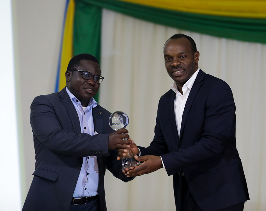 Minister of State for Local government in charge of Socio-Economic Development Cyriaque Harelimana awards FranÃ§ois Habitegeko mayor of Nyaruguru. Timothy Kisambira 