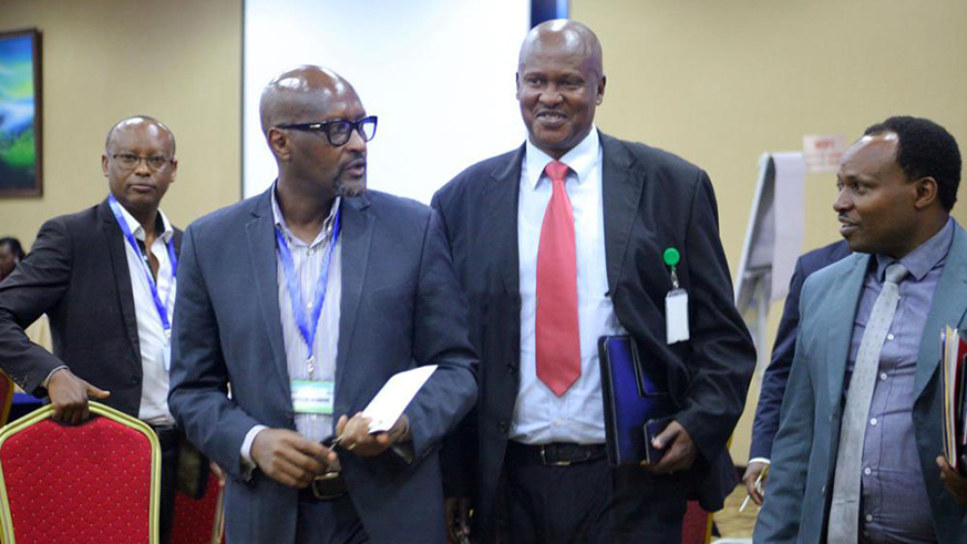 Rtd Brig. General Jean-Damascu00e8ne Sekamana (red tie) and his predecessor Vincent de Gaulle Nzamwita yesterday. / Courtesy