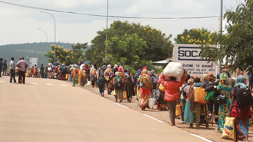 Burundian Asylum seekers queue at Nemba in Bugesera as they cross the border today