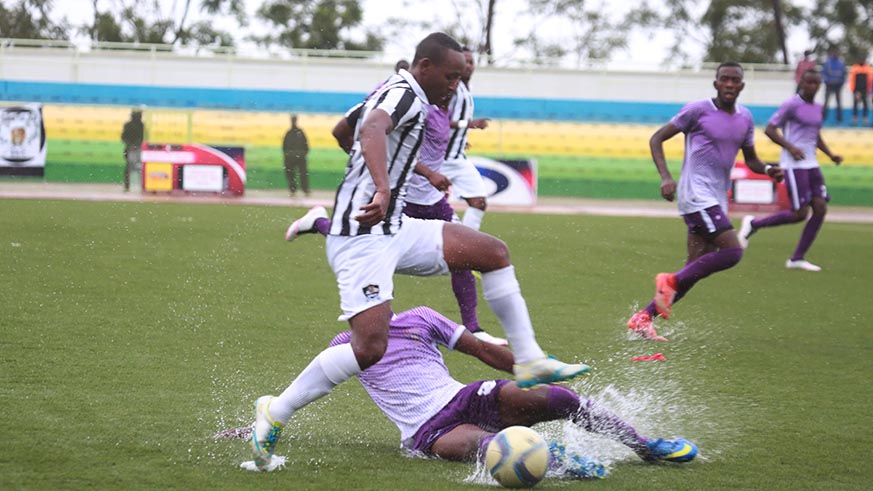 APR FC midfielder Jean Claude Iranzi beats for the ball La Jeunesse defender during a 3-0 match at Kigali Stadium (Sam Ngendahimana)